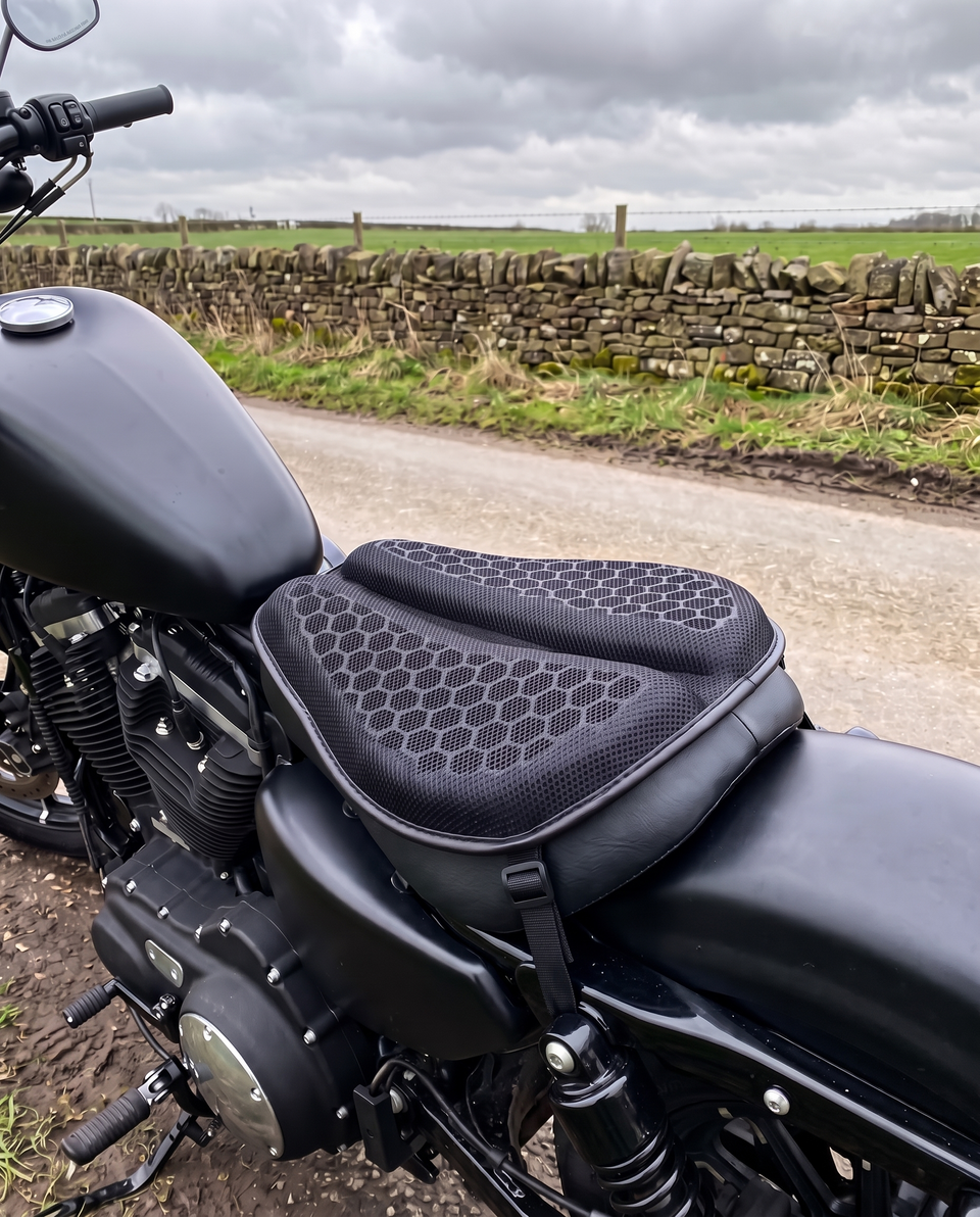 Gel seat pad strapped to the rider seat of a black cruiser