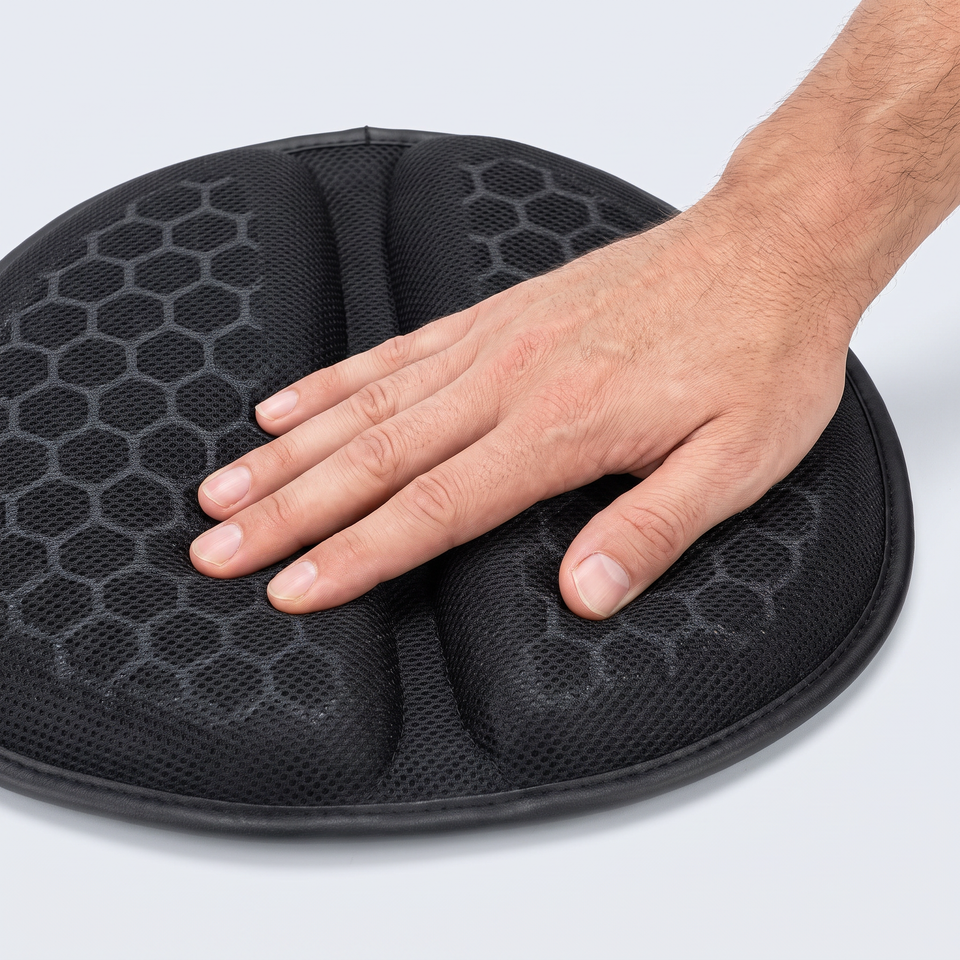 Hand pressing into the honeycomb gel of the MotoCush seat pad