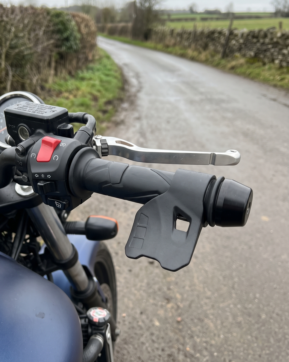 Throttle Cruise Assist clipped onto the right-hand throttle grip of a parked motorcycle