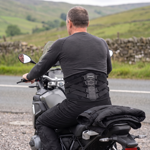 Rider sitting on his motorcycle in the riding position wearing the MotoSupport back support