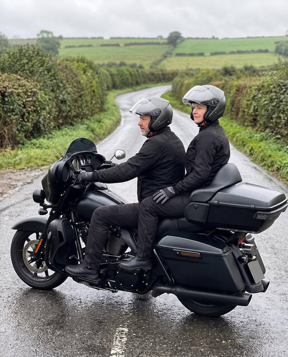 Couple riding two-up on a touring motorcycle on a UK country lane